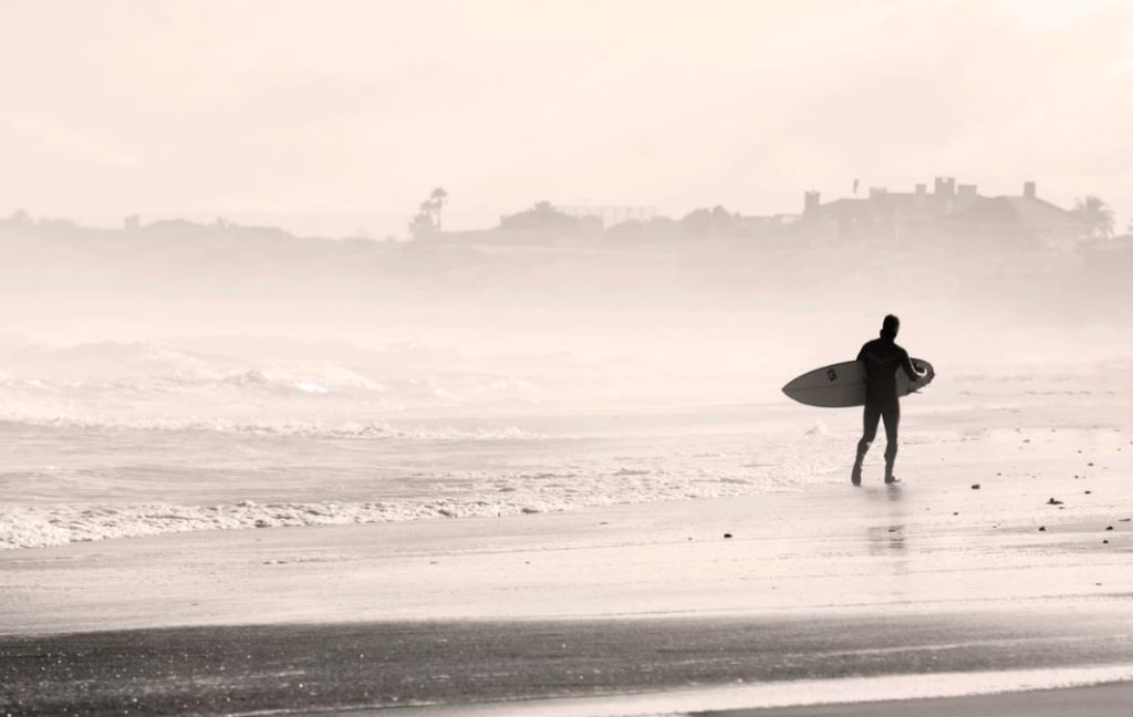 Surfer heading into the mist